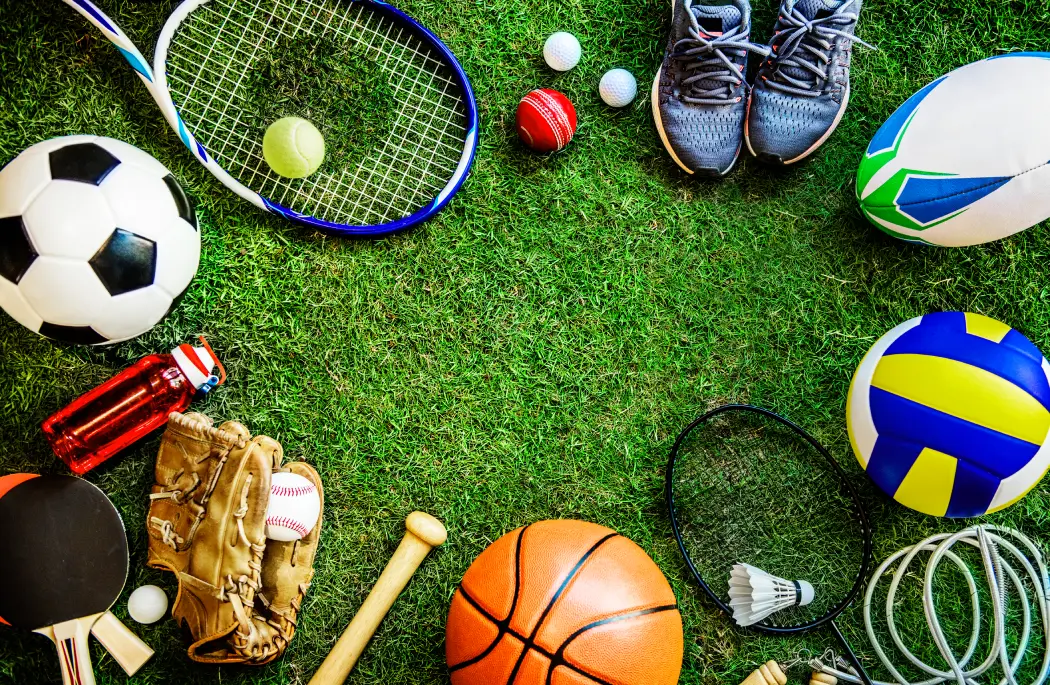 sports-equipment-and-balls-on-green-grass